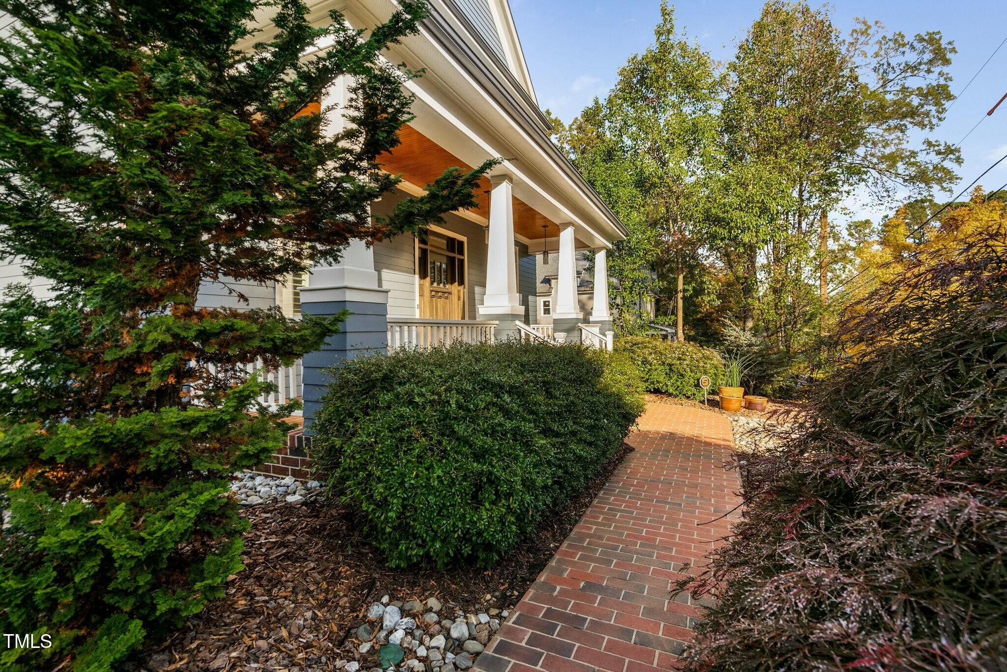 519 Peebles Street Raleigh, NC 27608 - Photo 4 of 43 a house with trees in front of it