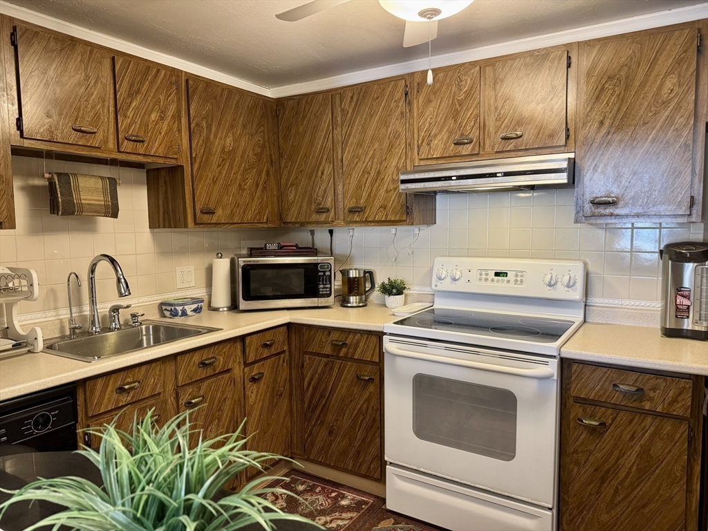 121 Tremont Street, Unit B1 Boston, MA 02135 - Photo 11 of 20 a kitchen with a sink stove and cabinets
