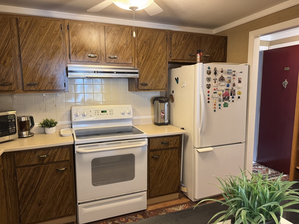 121 Tremont Street, Unit B1 Boston, MA 02135 - Photo 12 of 20 a kitchen with appliances a refrigerator and a sink