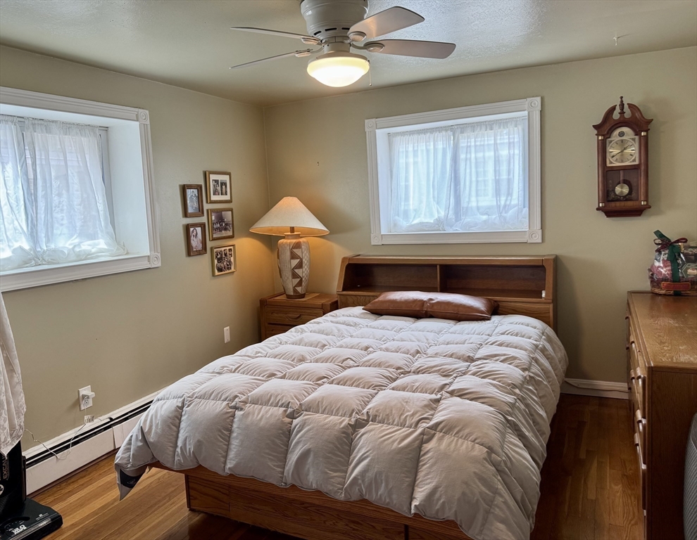 121 Tremont Street, Unit B1 Boston, MA 02135 - Photo 13 of 20 a bed sitting in a bedroom next to a window
