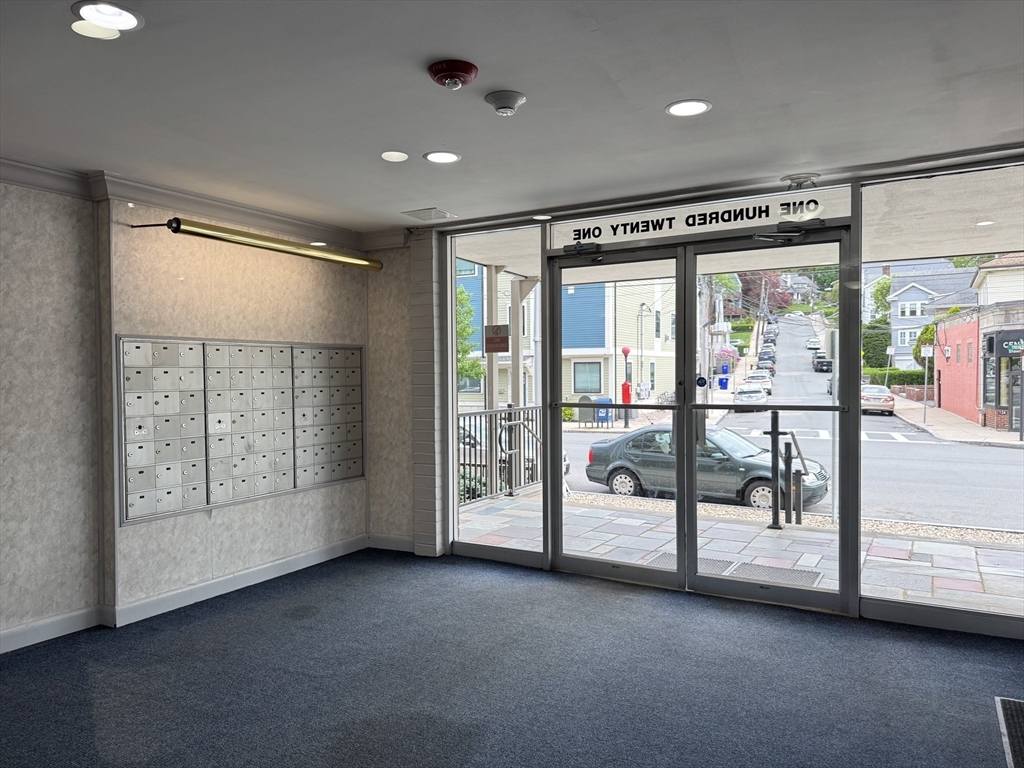 121 Tremont Street, Unit B1 Boston, MA 02135 - Photo 3 of 20 a view of an empty room with windows