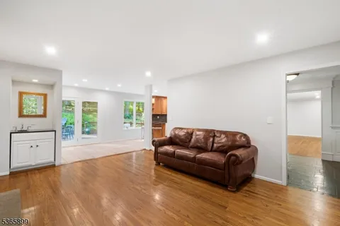 a living room with furniture and a hard wood floor