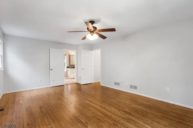 a view of an empty room and wooden floor