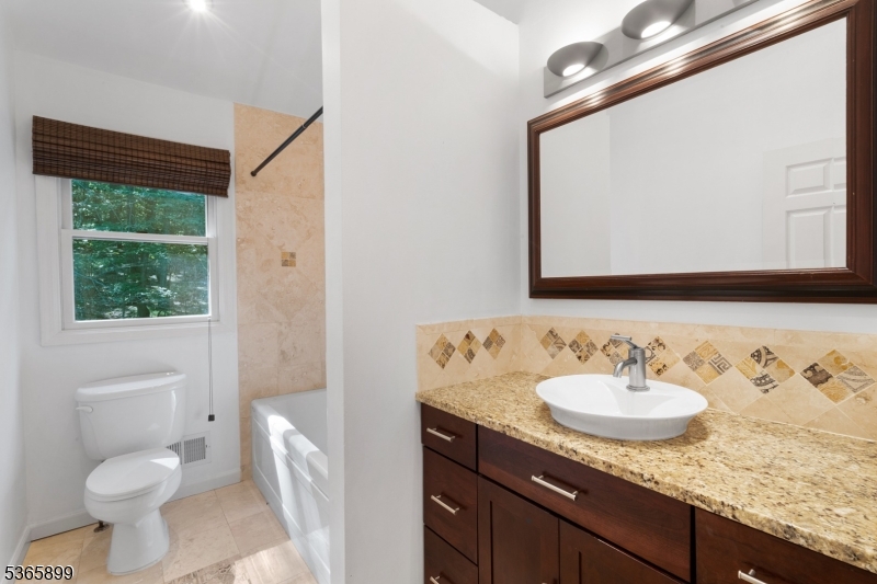 67 Frog Hollow Road Califon, NJ 07830 - Photo 24 of 31 a bathroom with a granite countertop sink a toilet and a mirror
