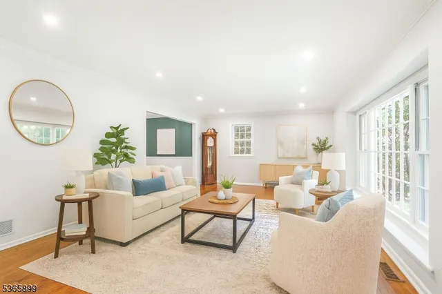 a living room with furniture a rug and a large window