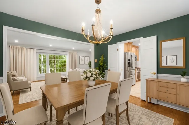 a dining room with furniture a chandelier and wooden floor