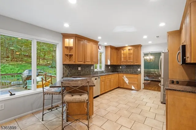 a kitchen with a sink and chairs