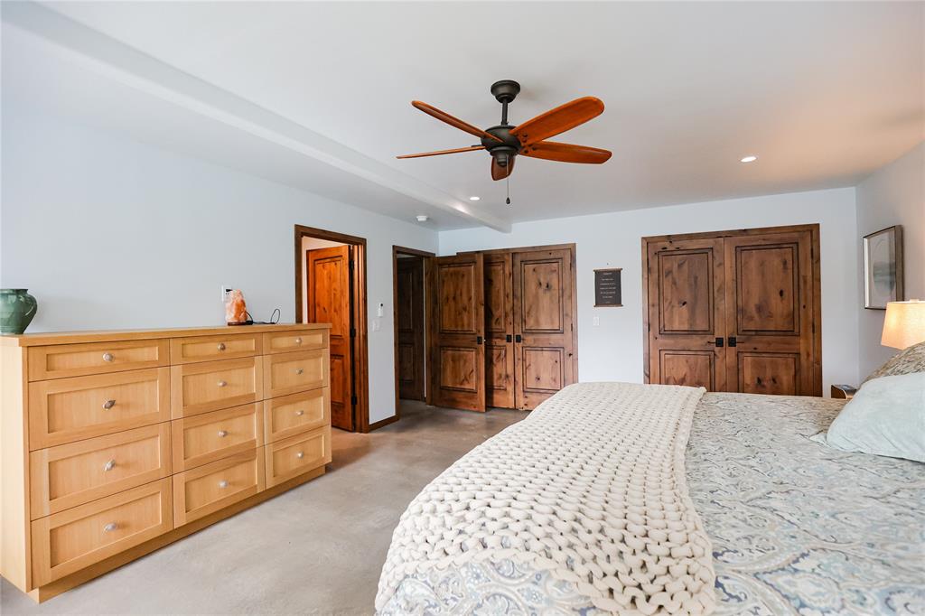 1250 County Road Brady, TX 76825 - Photo 18 of 40 a bedroom with a large bed and a dresser
