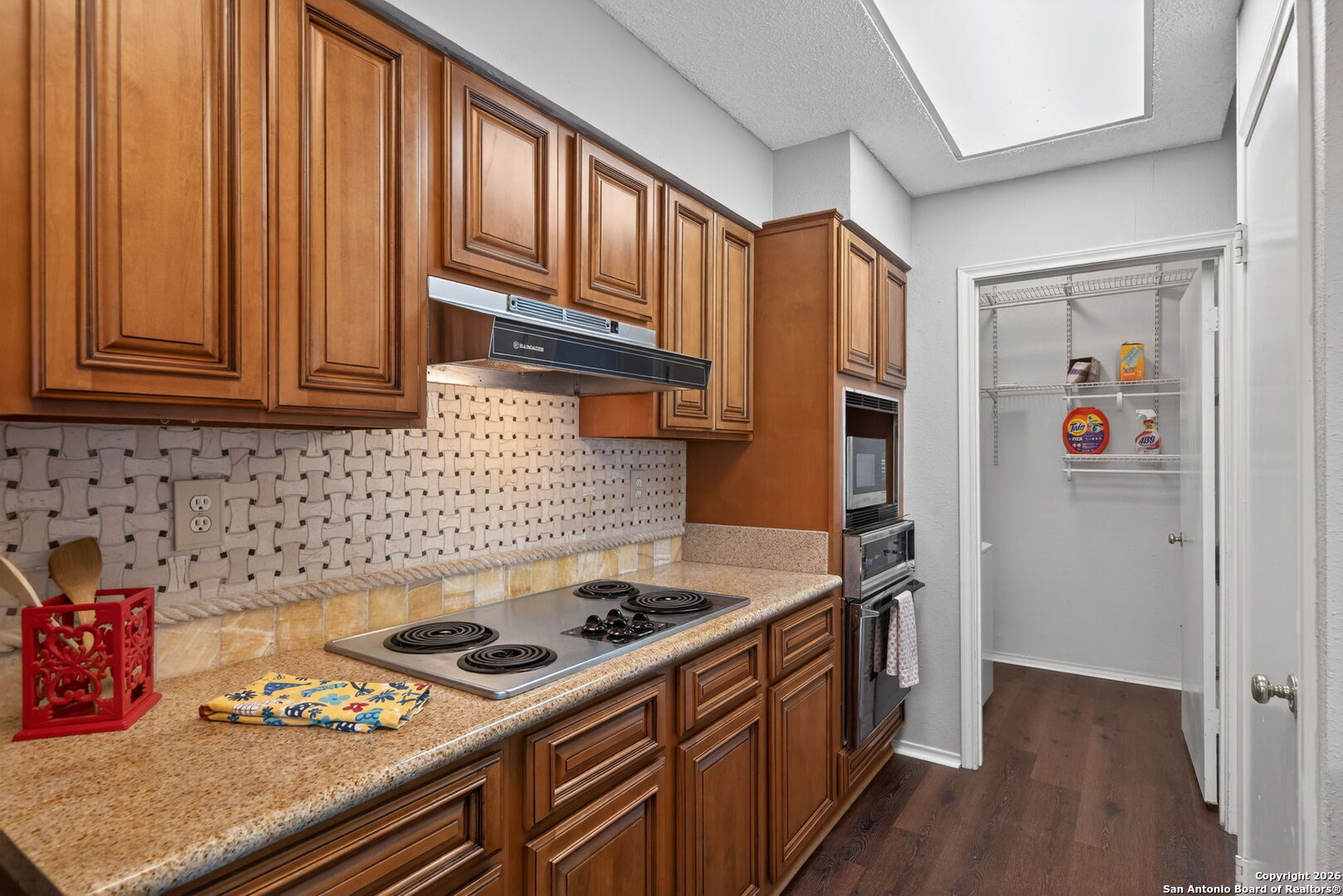11001 Wurzbach Road, Unit 605 San Antonio, TX 78230 - Photo 11 of 47 a kitchen with stainless steel appliances granite countertop a stove and a refrigerator