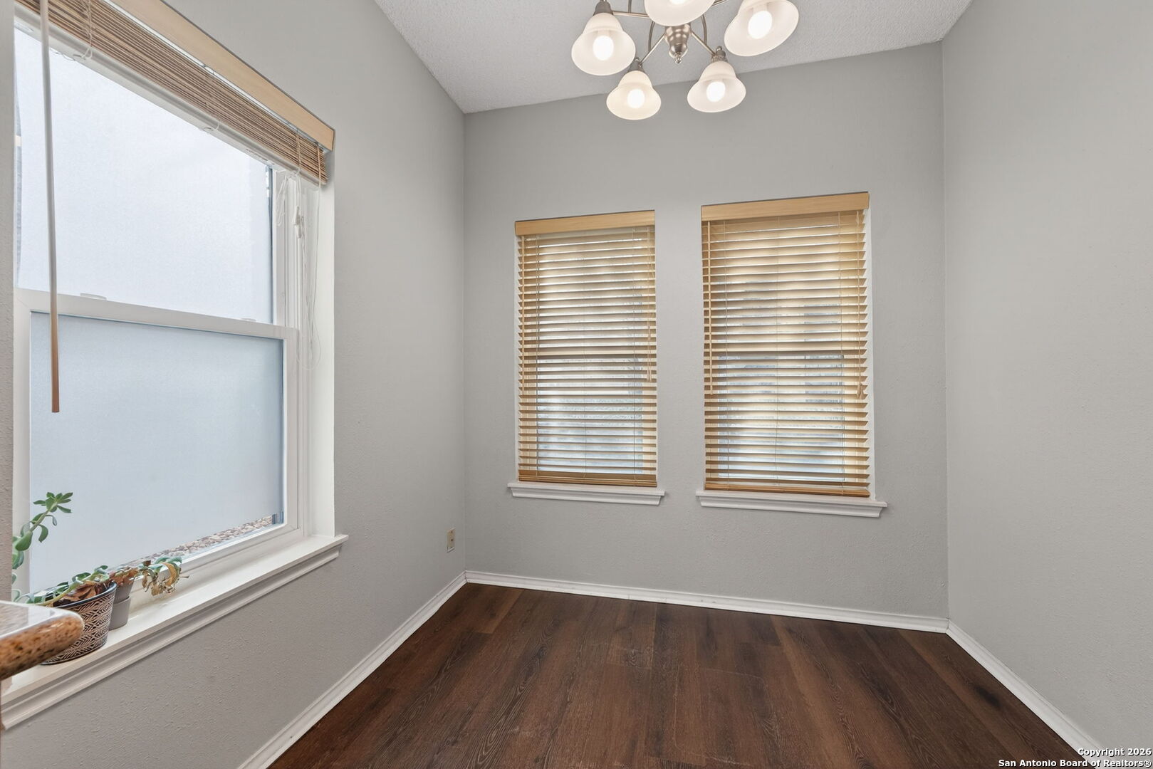 11001 Wurzbach Road, Unit 605 San Antonio, TX 78230 - Photo 12 of 47 a view of an empty room with wooden floor and a window