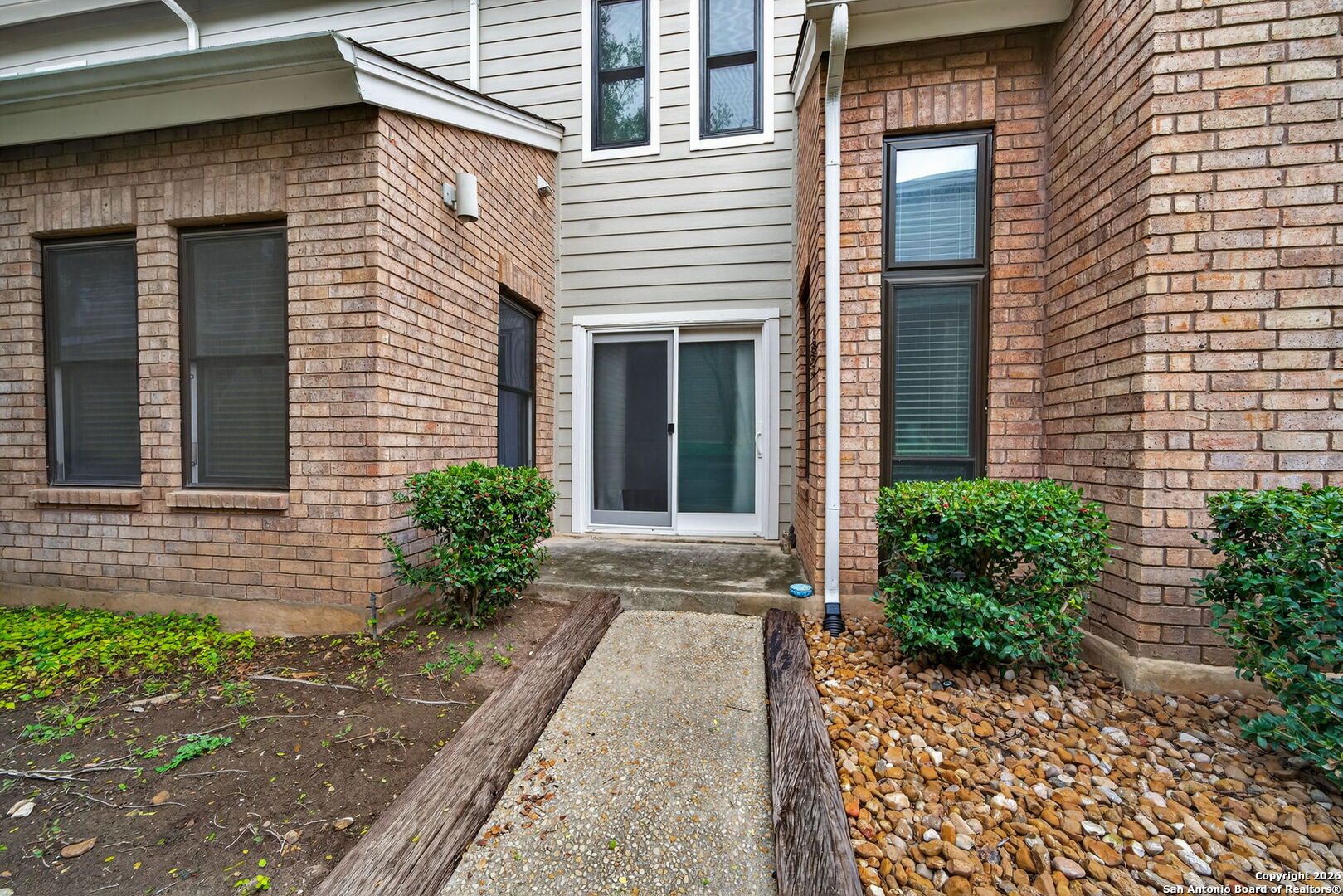 11001 Wurzbach Road, Unit 605 San Antonio, TX 78230 - Photo 33 of 47 a front view of a house with garden