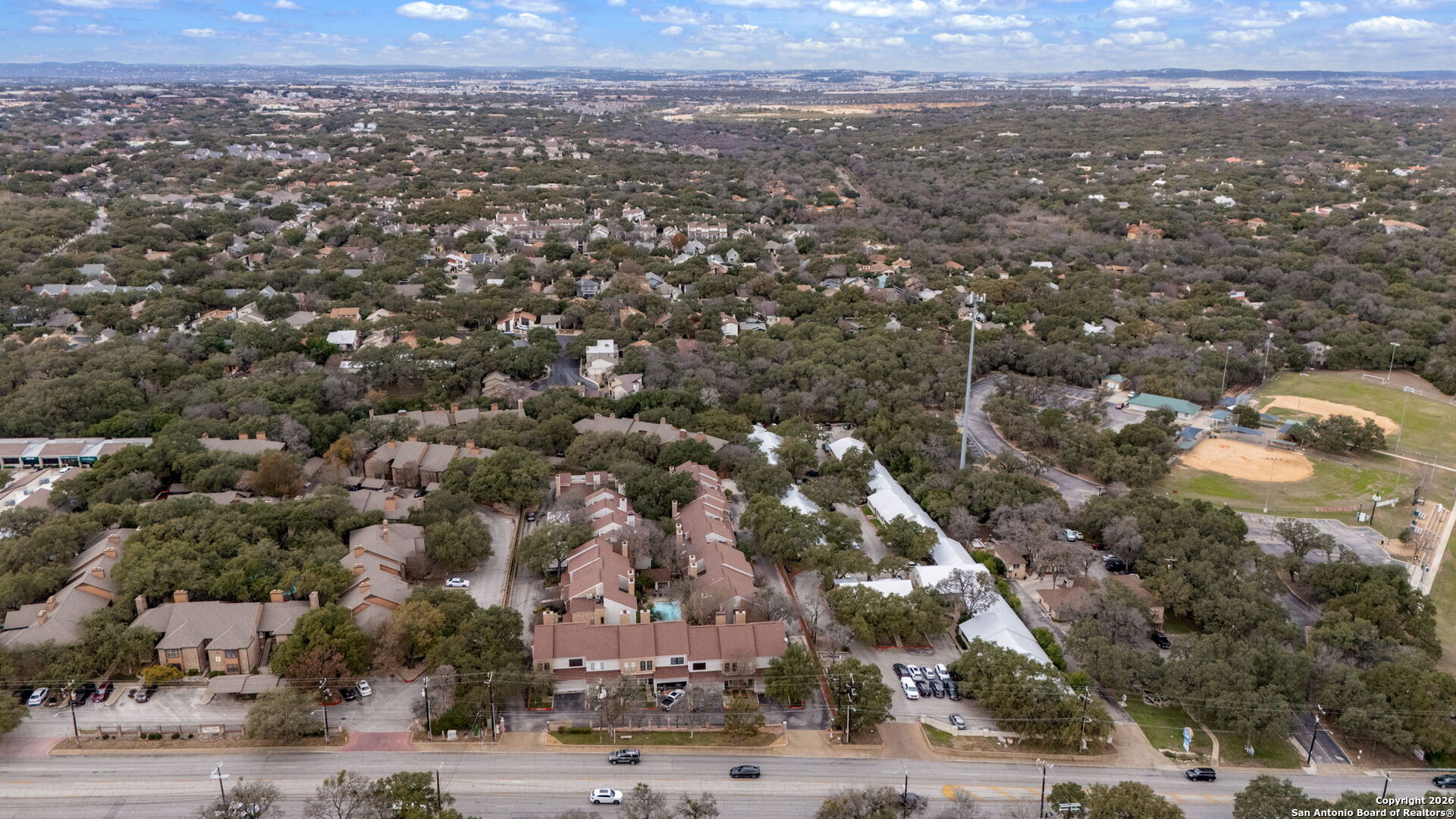 11001 Wurzbach Road, Unit 605 San Antonio, TX 78230 - Photo 46 of 47 an aerial view of residential houses with outdoor space and trees