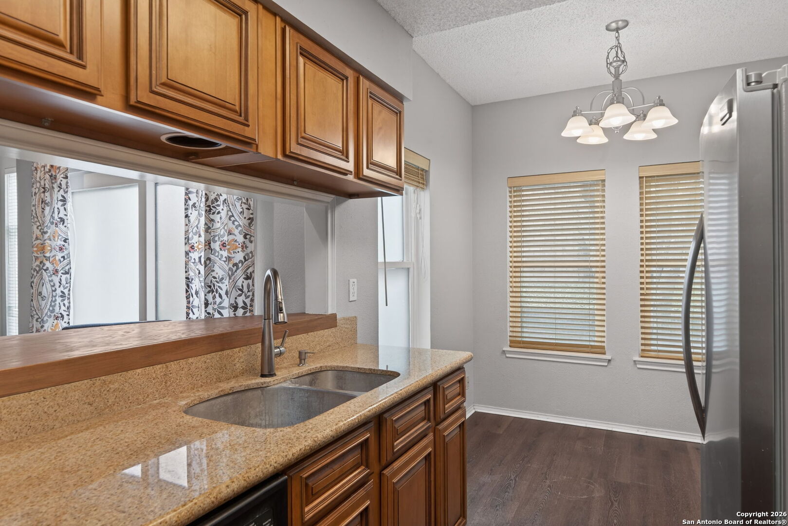 11001 Wurzbach Road, Unit 605 San Antonio, TX 78230 - Photo 10 of 47 a kitchen with granite countertop a sink and cabinets