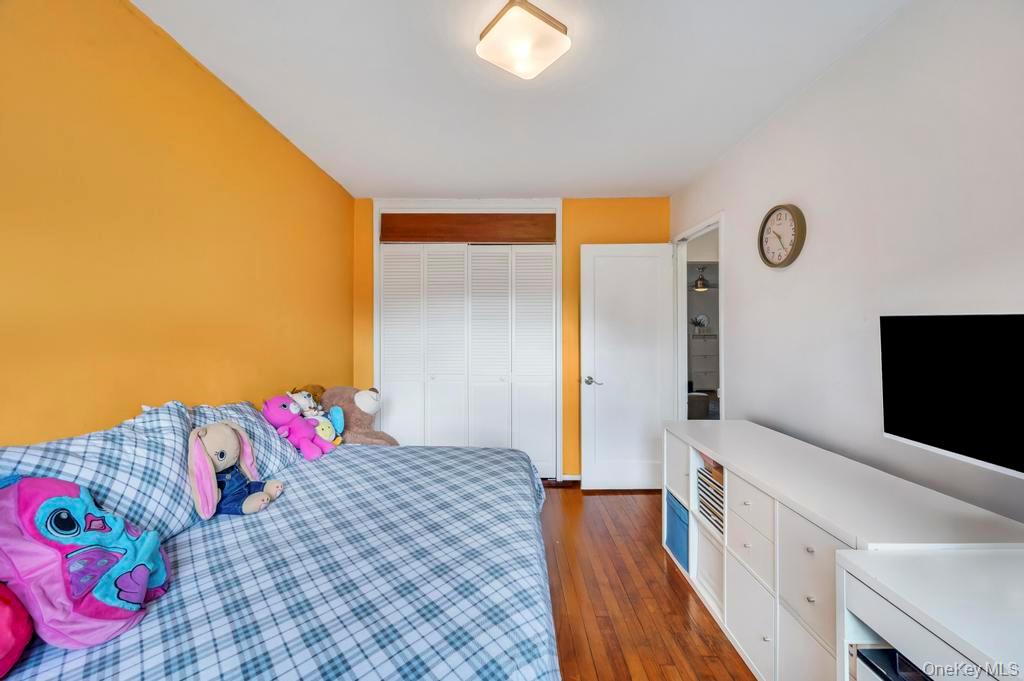196-72 69th Avenue, Unit 1 Queens, NY 11365 - Photo 15 of 23 Bedroom with dark wood-type flooring and a closet
