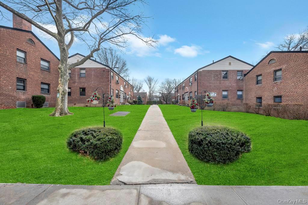 196-72 69th Avenue, Unit 1 Queens, NY 11365 - Photo 19 of 23 View of home's community with a lawn