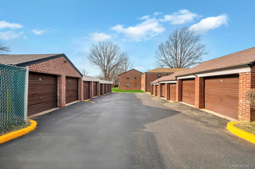 196-72 69th Avenue, Unit 1 Queens, NY 11365 - Photo 22 of 23 Garage featuring a residential view