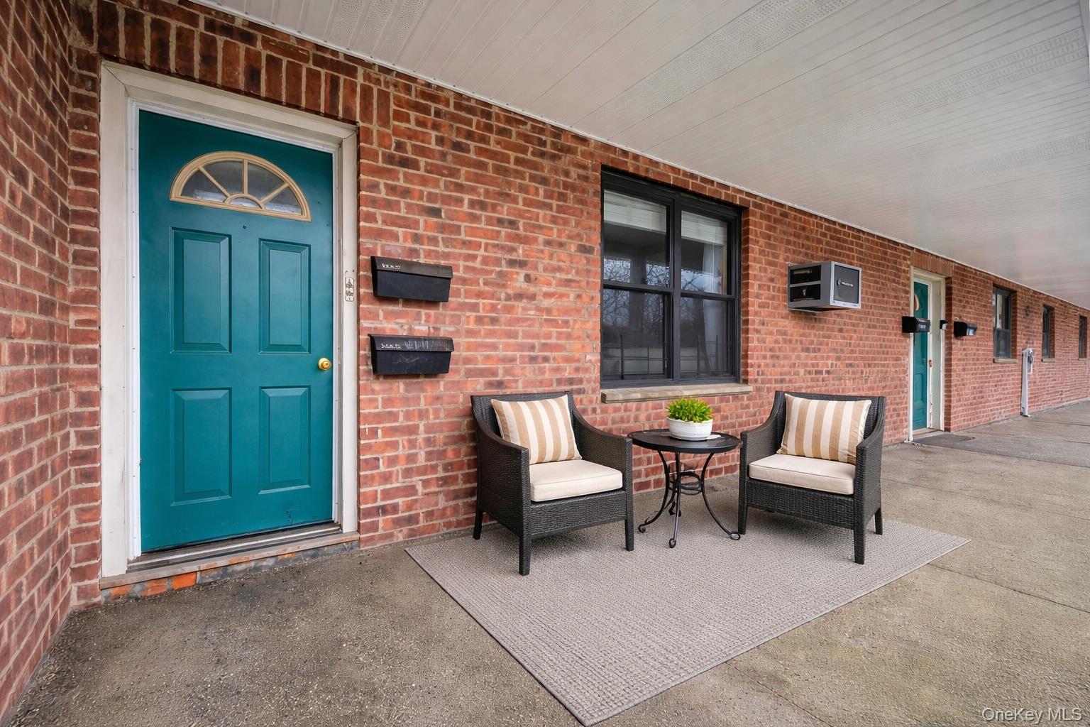 196-72 69th Avenue, Unit 1 Queens, NY 11365 - Photo 4 of 23 Entrance to property featuring brick siding and a patio area