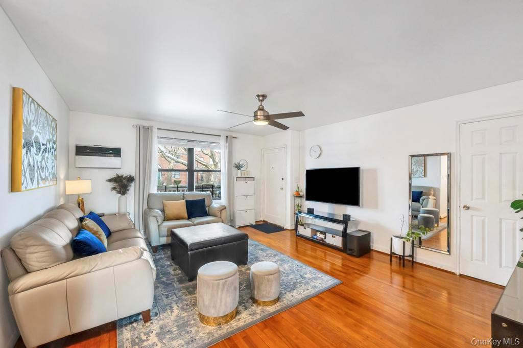 196-72 69th Avenue, Unit 1 Queens, NY 11365 - Photo 5 of 23 Living room featuring light wood-style floors and ceiling fan