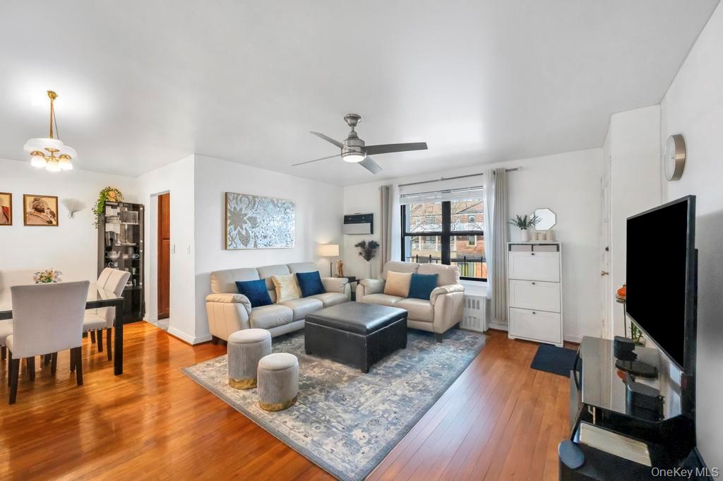 196-72 69th Avenue, Unit 1 Queens, NY 11365 - Photo 7 of 23 Living room featuring hardwood / wood-style floors, a ceiling fan, and radiator heating unit