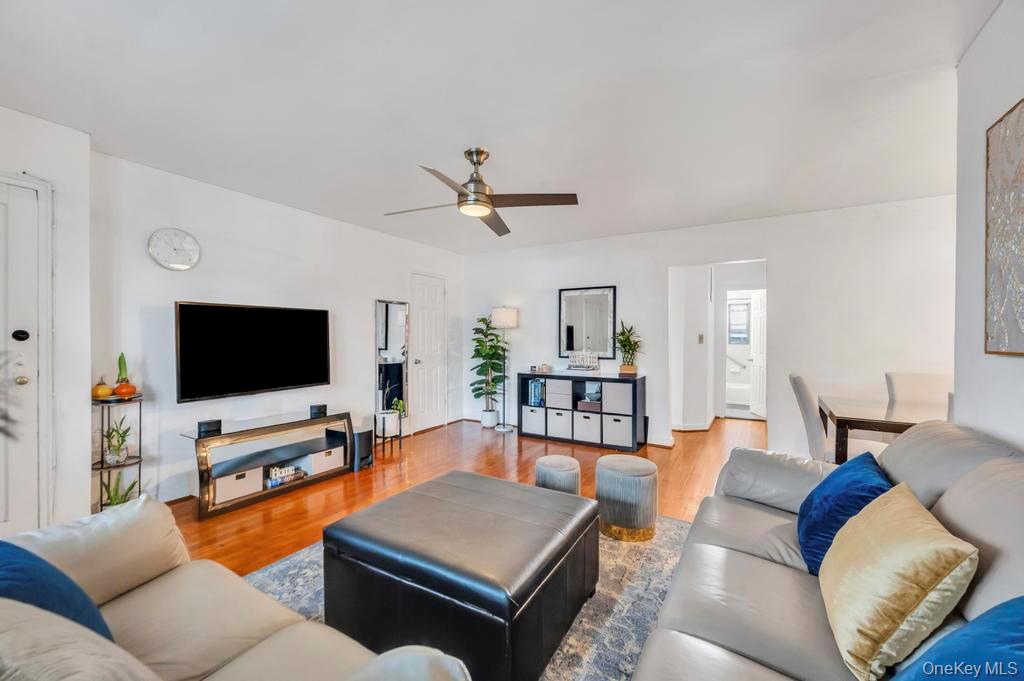 196-72 69th Avenue, Unit 1 Queens, NY 11365 - Photo 8 of 23 Living area featuring a ceiling fan and wood finished floors