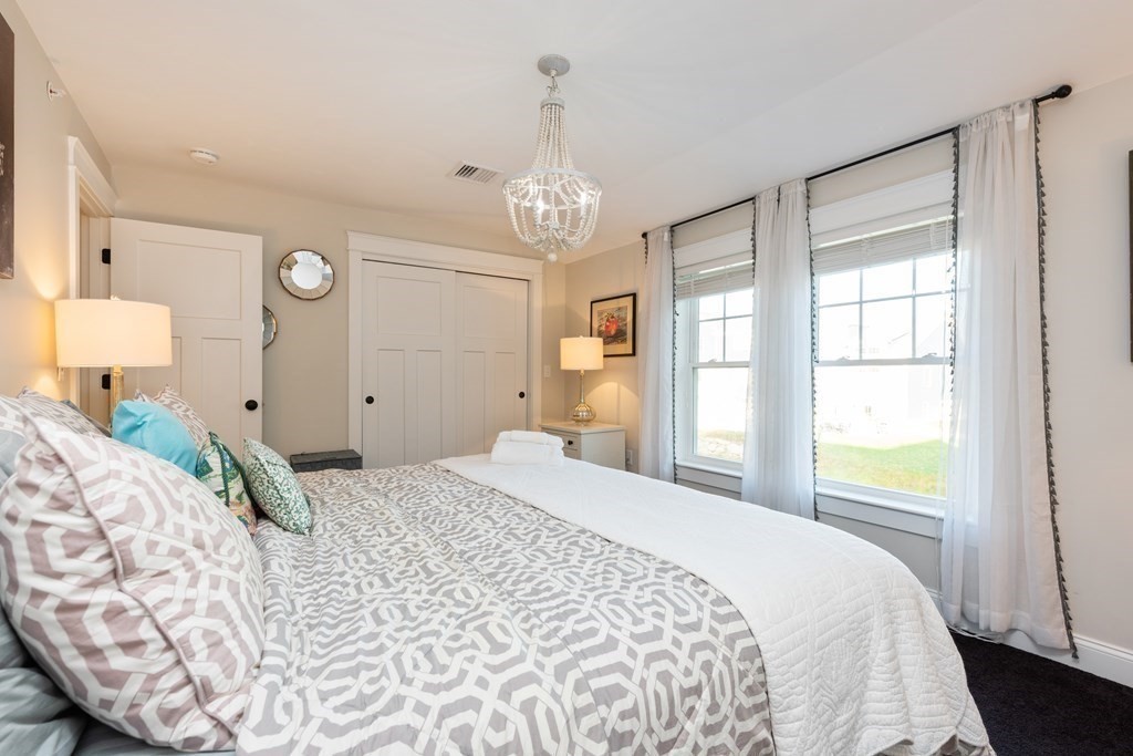 12 Ocean Pines Drive, Unit E Bourne, MA 02562 - Photo 25 of 28 a bedroom with a large bed and a window