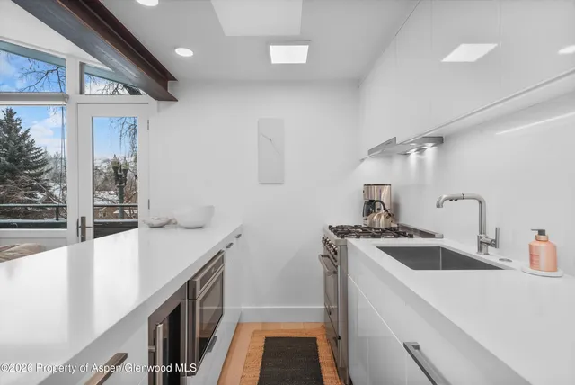 a kitchen that has a sink and a stove