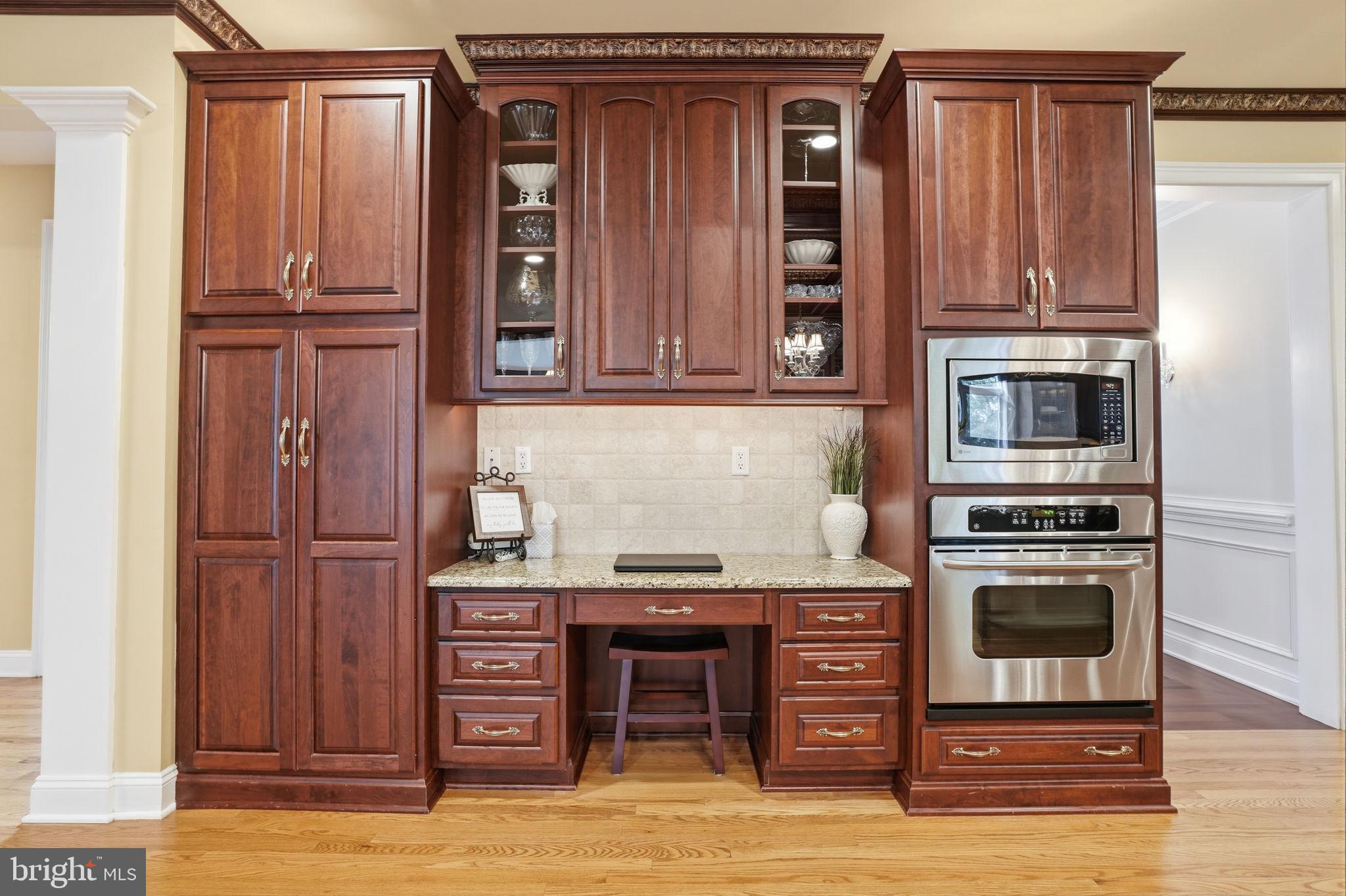 1588 Wrightstown Road Newtown, PA 18940 - Photo 30 of 81 a kitchen with stainless steel appliances granite countertop a stove and a refrigerator with wooden floor