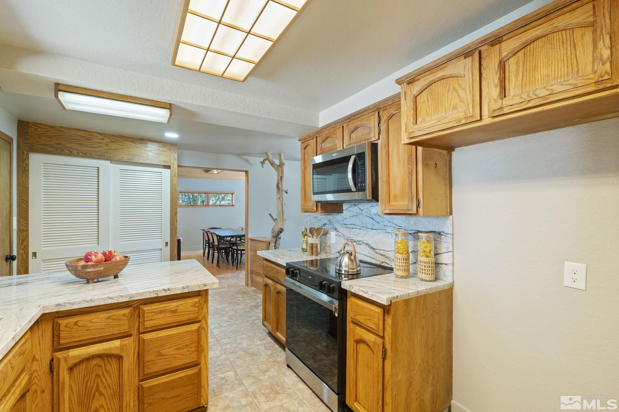 888 Dresslerville Road Gardnerville, NV 89460 - Photo 11 of 35 a kitchen with stainless steel appliances granite countertop a sink stove and cabinets