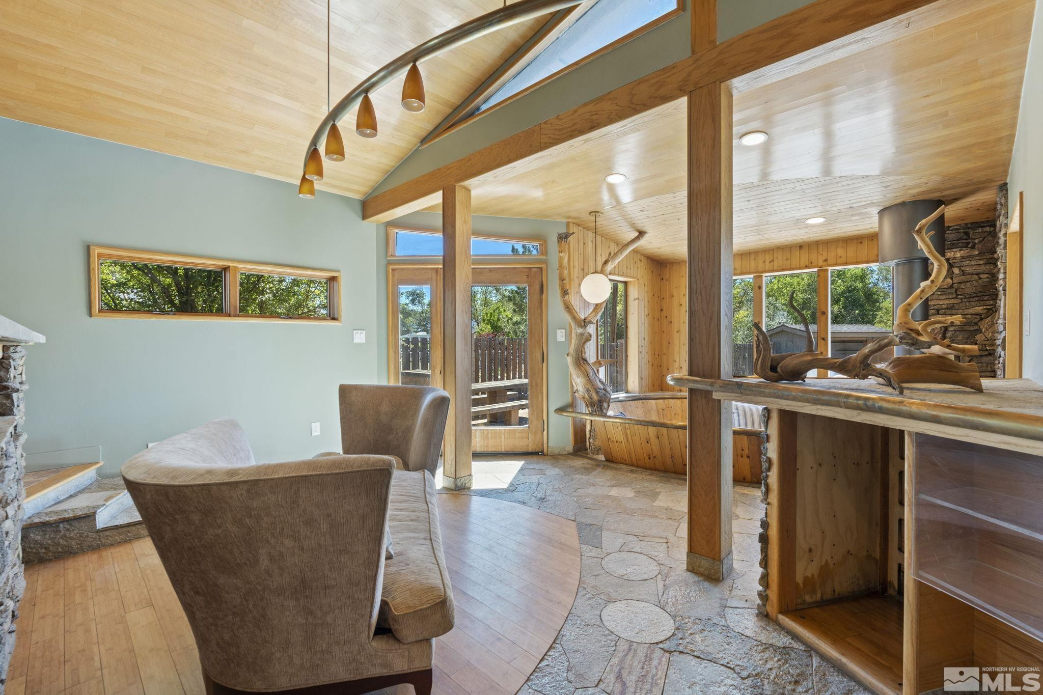 888 Dresslerville Road Gardnerville, NV 89460 - Photo 15 of 35 a living room with couches a coffee table and a large window with garden view