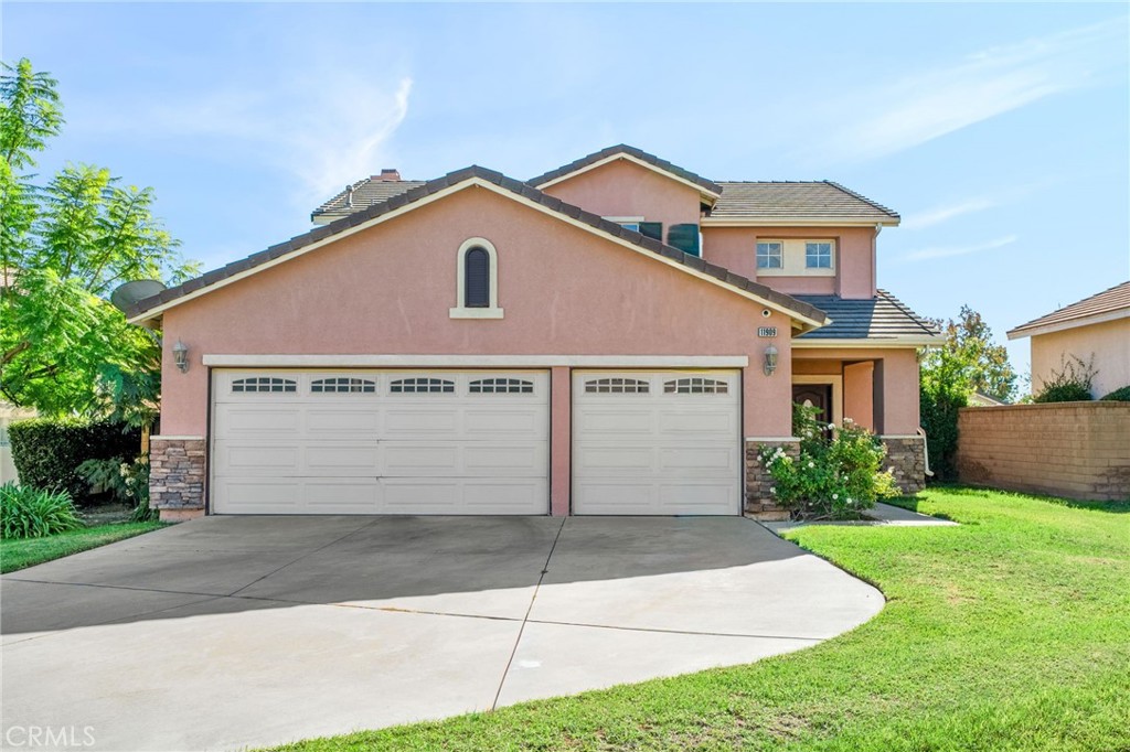 11909 Stegmeir Drive Rancho Cucamonga, CA 91739 - Photo 1 of 1 a front view of a house with a yard and garage