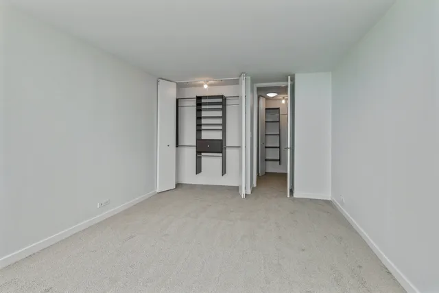an empty room with closet and a window