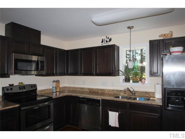 1137 South State Street Raleigh, NC 27601 - Photo 3 of 12 a kitchen with granite countertop a sink stainless steel appliances and cabinets