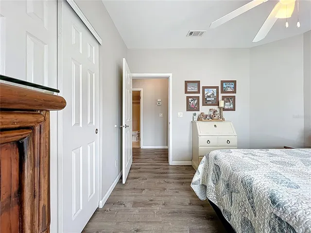 a view of a bedroom with wooden floor and closet