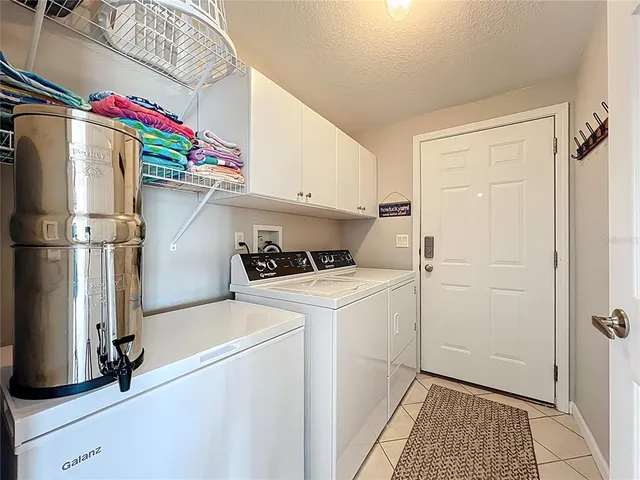 a view of washer and dryer with kitchen in the background