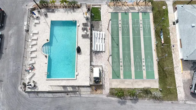 a view of pool with lawn chairs and a big yard