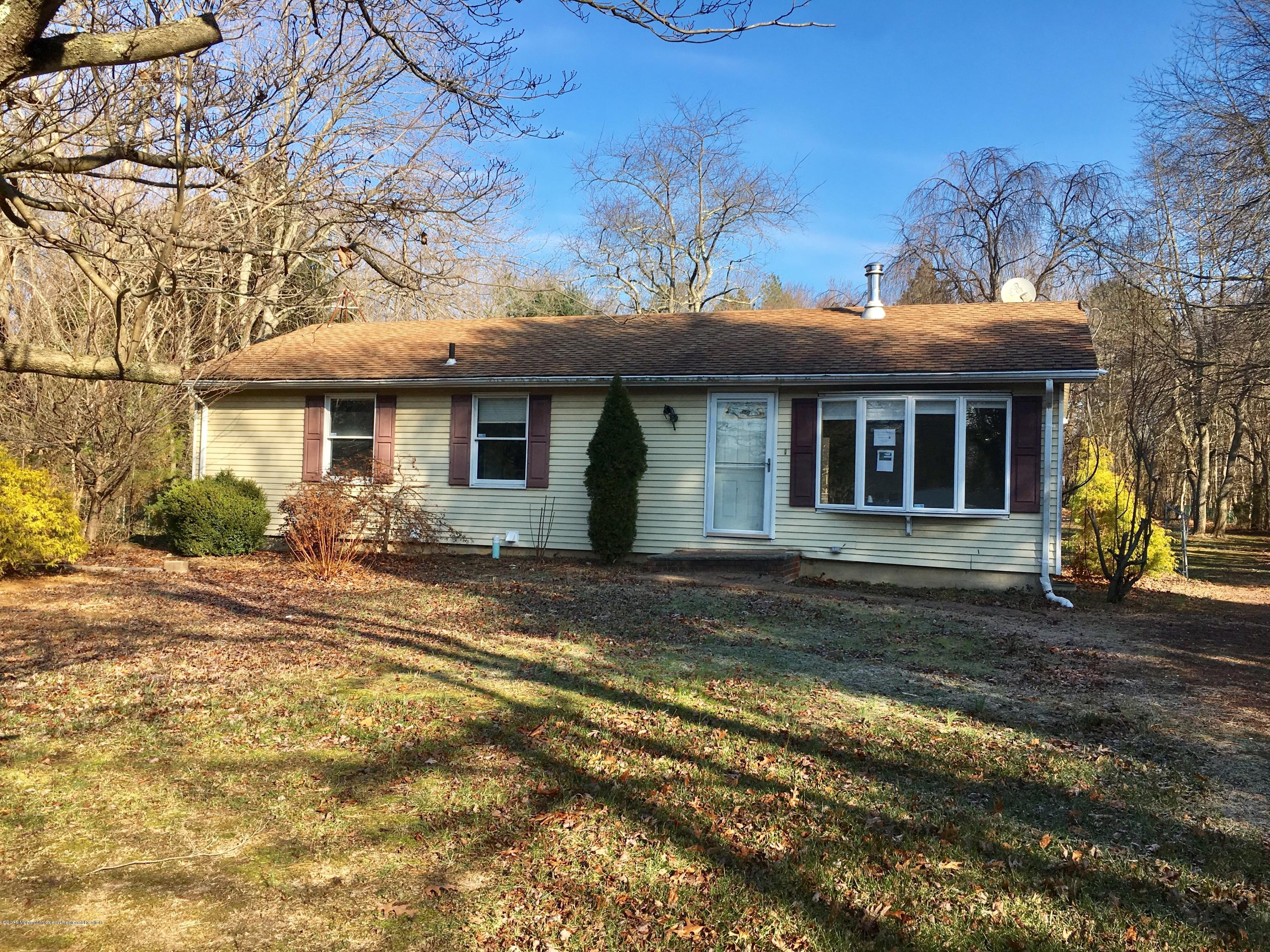 627 Leesville Road Jackson, NJ 08527 - Photo 2 of 17 a view of a white house next to a yard with plants and trees