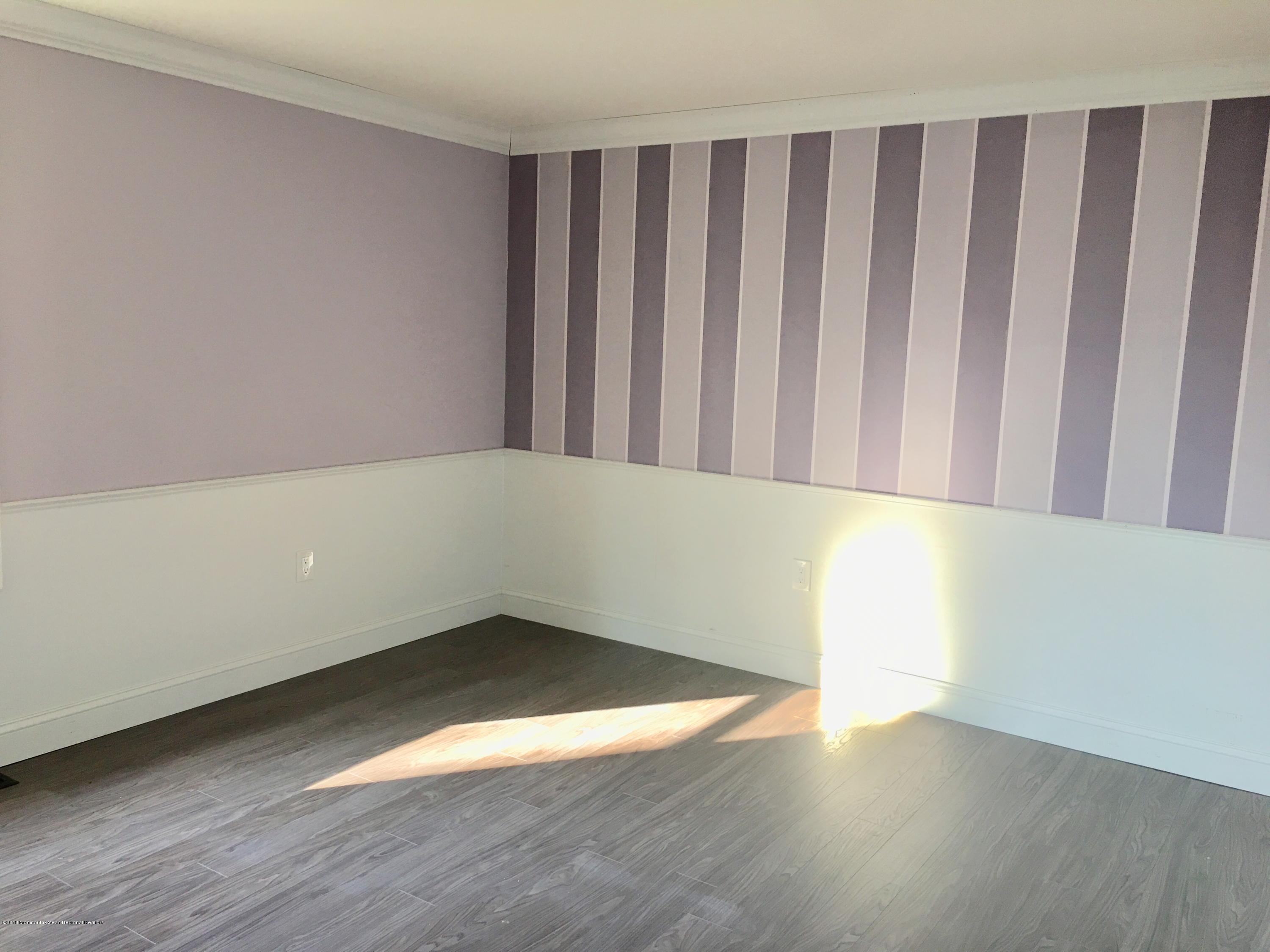 627 Leesville Road Jackson, NJ 08527 - Photo 11 of 17 a view of wooden floor in a room