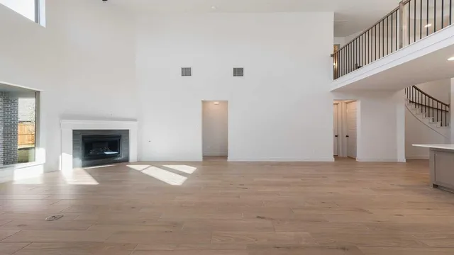 a view of an empty room with a fireplace and a window