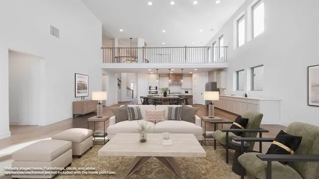 a living room with furniture kitchen view and a chandelier