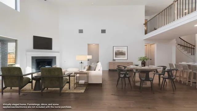 a living room with furniture a dining table and a fireplace