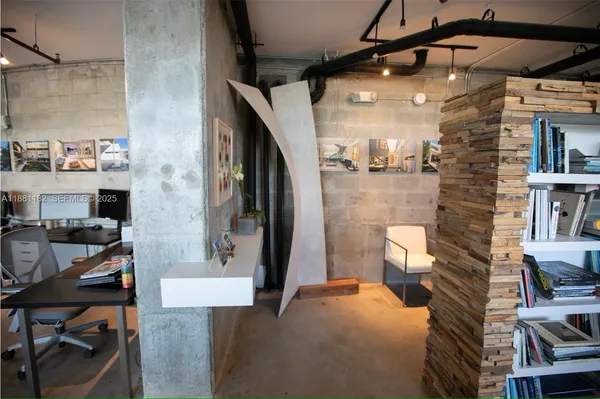 a workspace with furniture and a fireplace