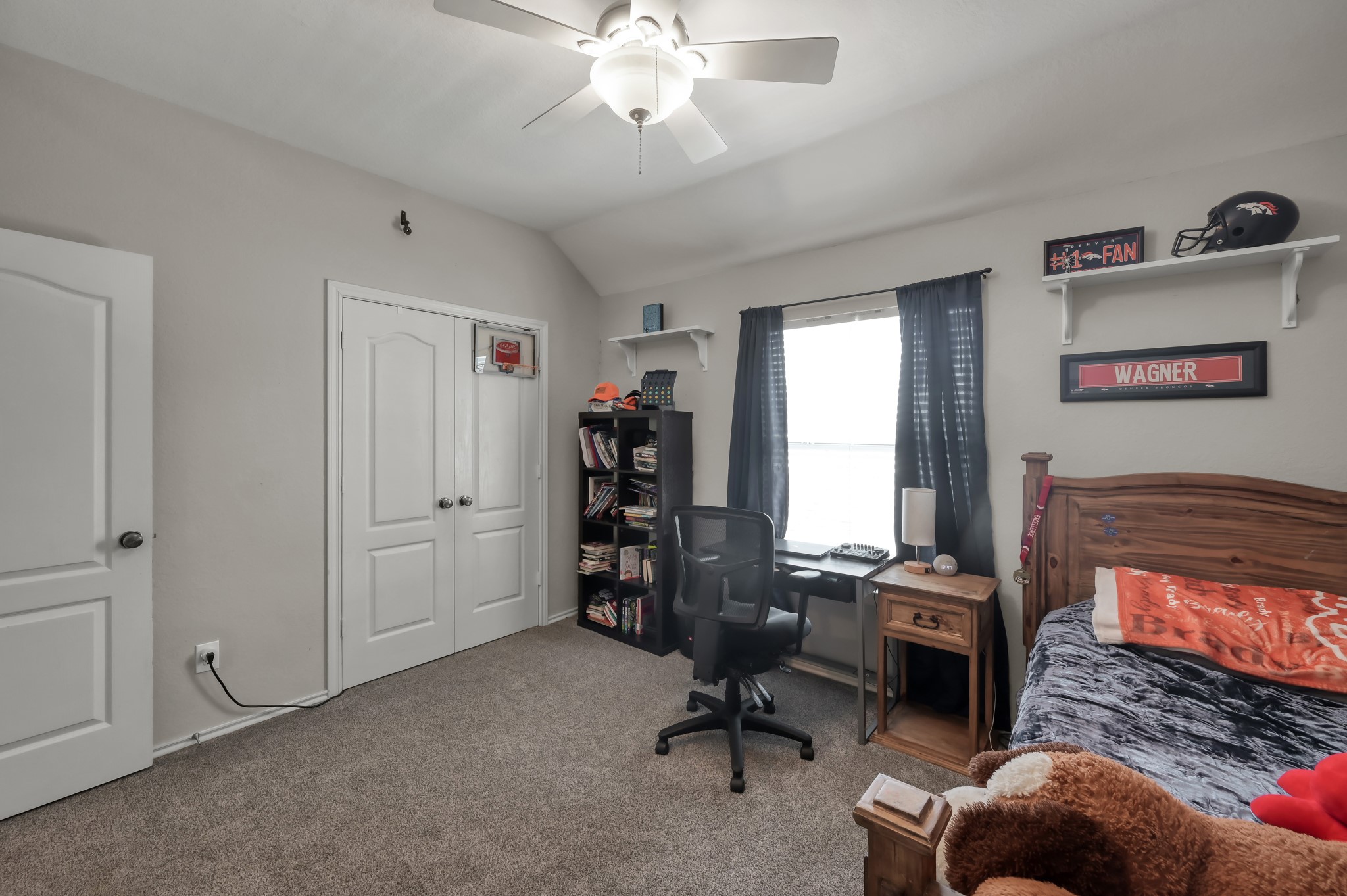 28522 Misty Cliff Lane Spring, TX 77386 - Photo 8 of 12 Secondary bedroom with vaulted ceiling, neutral tones, and dedicated workspace by the window. Thoughtfully designed with ample space for furniture and storage.
