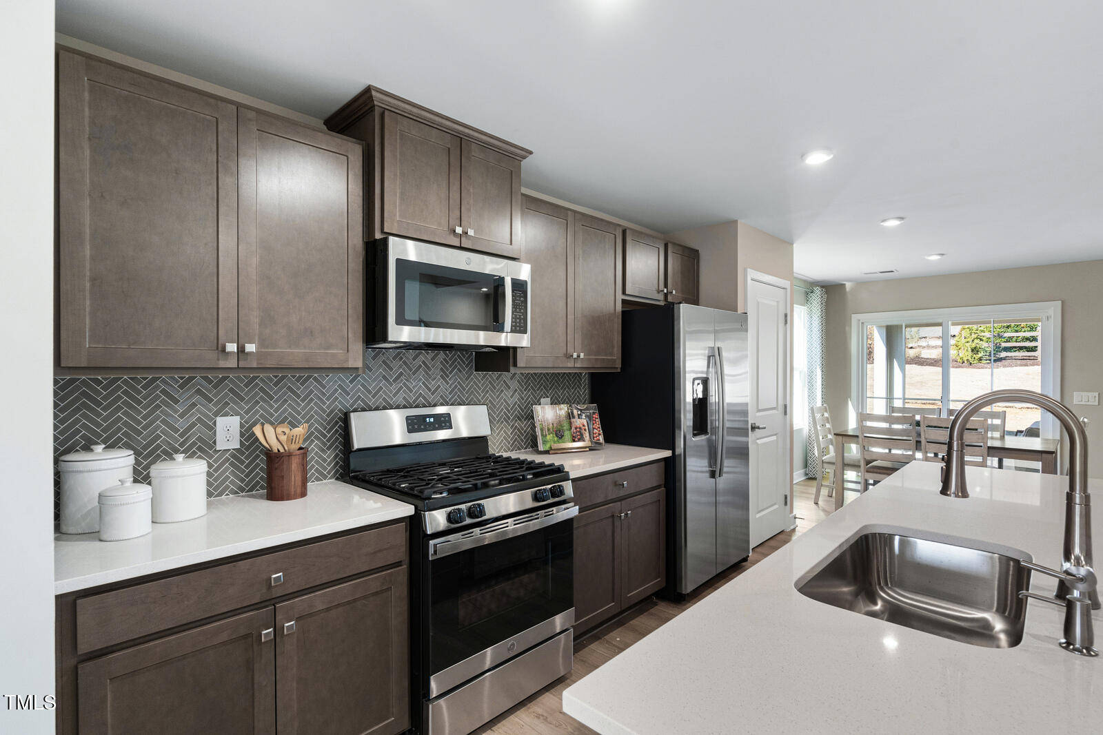 408 Grand Silo Road Raleigh, NC 27603 - Photo 3 of 25 a kitchen with granite countertop a sink stainless steel appliances and cabinets