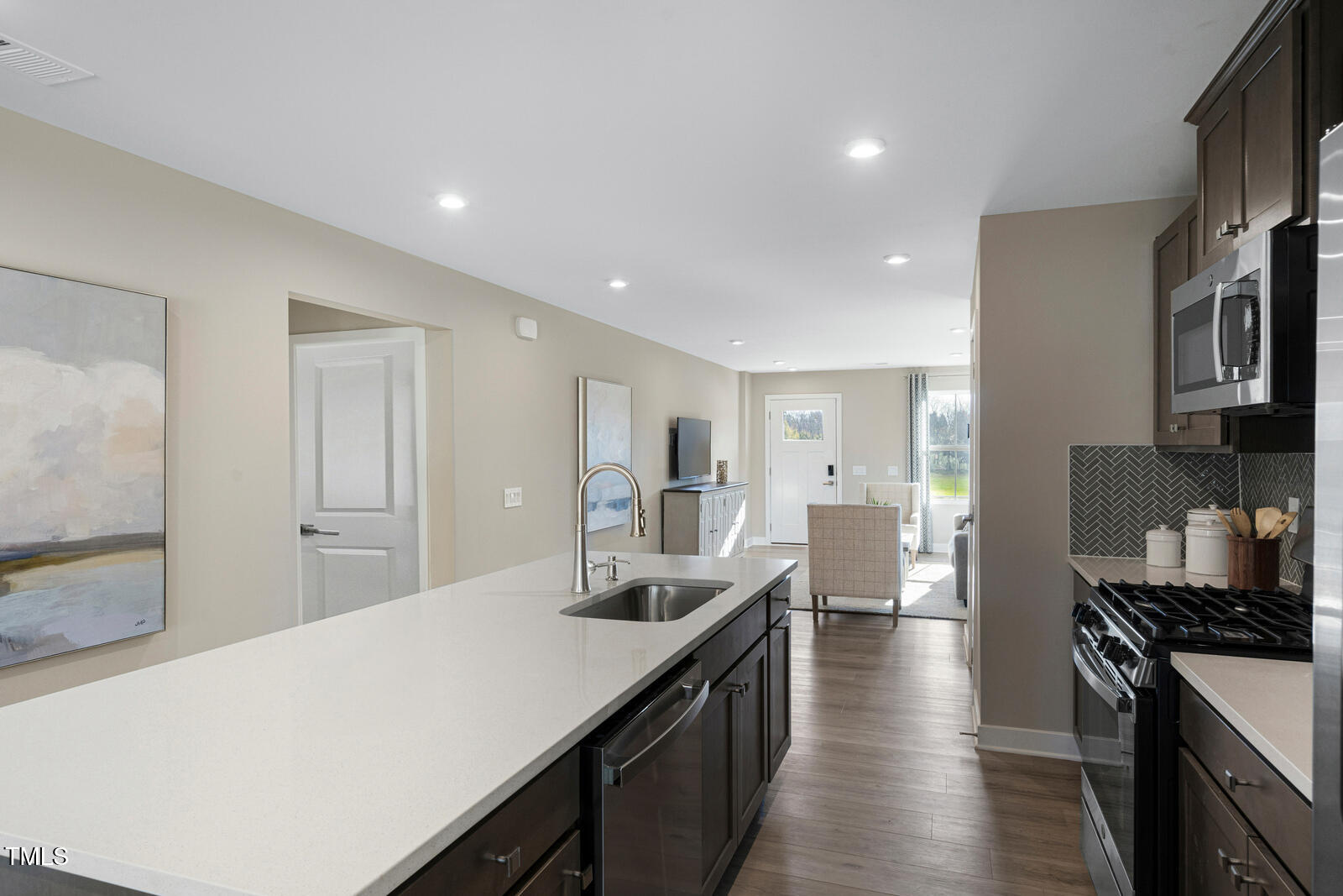 408 Grand Silo Road Raleigh, NC 27603 - Photo 8 of 25 a large kitchen with stainless steel appliances a lot of counter space and wooden floor