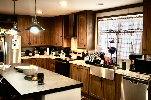 a kitchen with a sink a stove and chairs