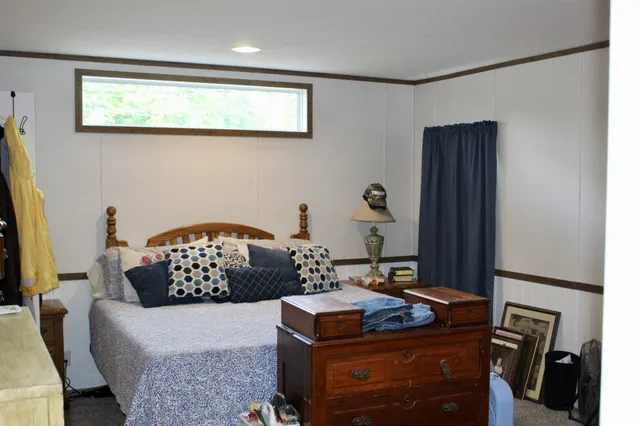 a bedroom with a bed and a dresser