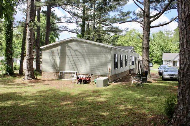 a view of a house with backyard and sitting area