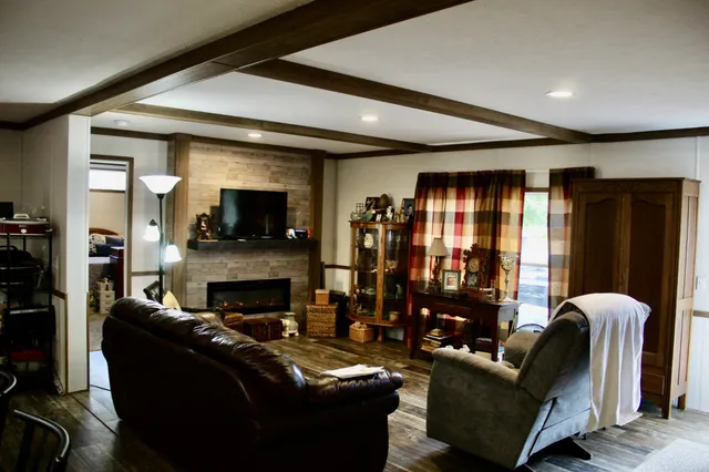 a living room with furniture and a fireplace