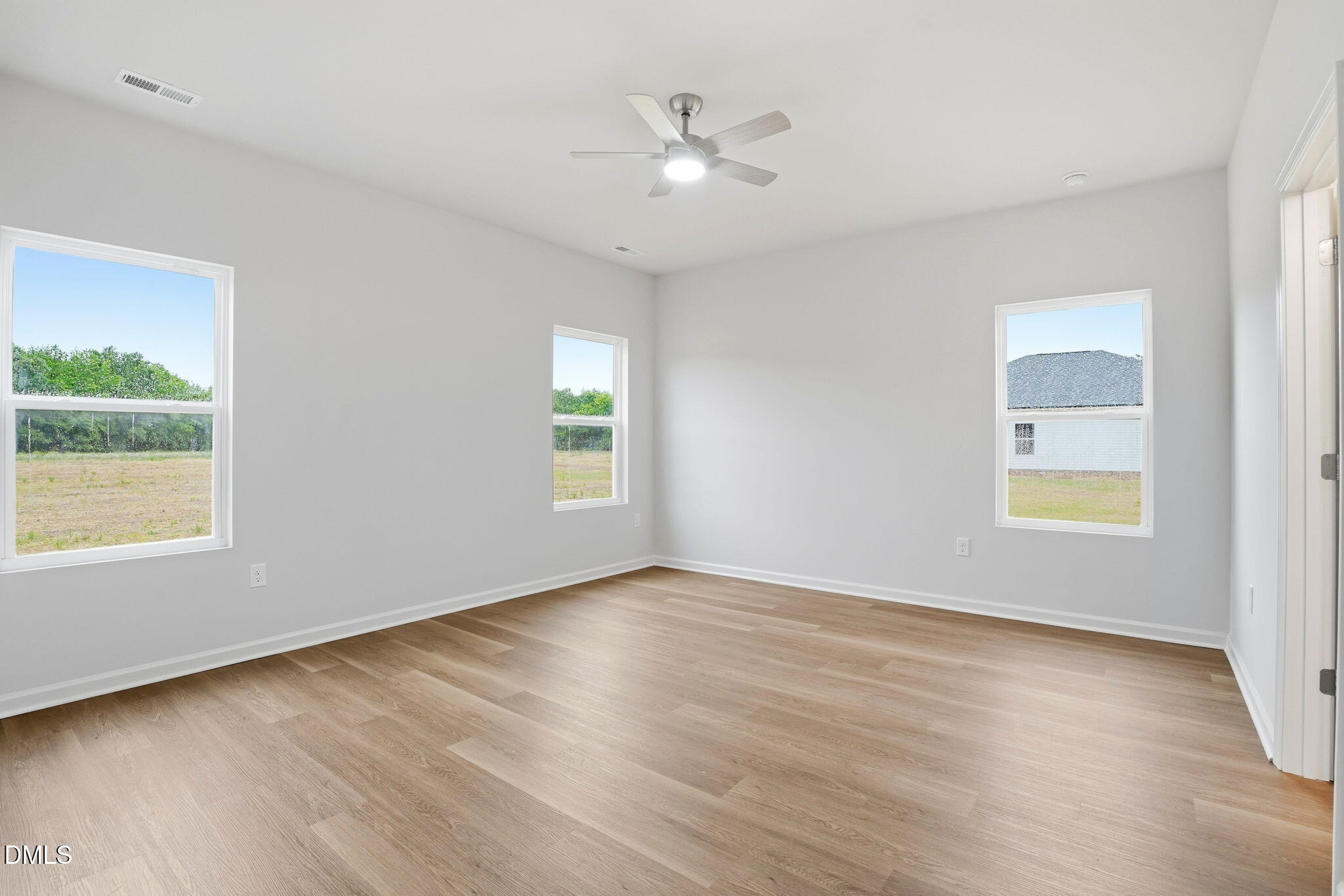 9019 Phoenix Court Spring Hope, NC 27882 - Photo 21 of 34 an empty room with window and wooden floor
