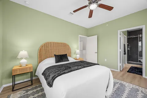 a bedroom with a bed and a chandelier
